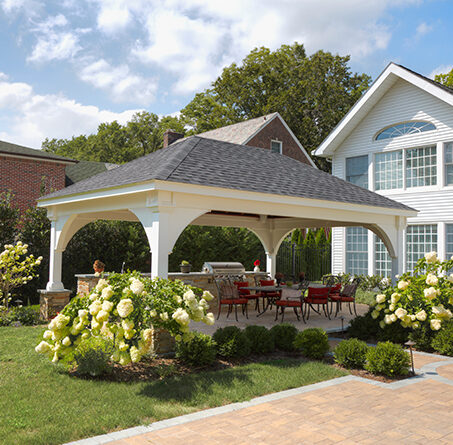 16 foot by 24 foot Grand Estate style vinyl pavilion over an outdoor cooking and dining area.