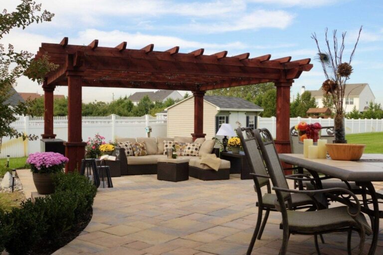 Artisan style wooden pergola with outdoor seating area and a nearby dining area.