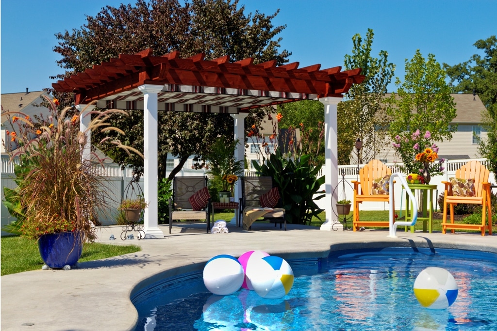 Artisan Wood Pergola with E Z Shade System next to a pool.