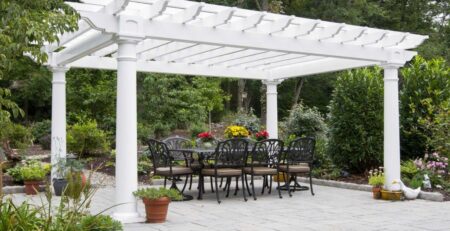 White vinyl, artisan style, pergola with an outdoor dining area.
