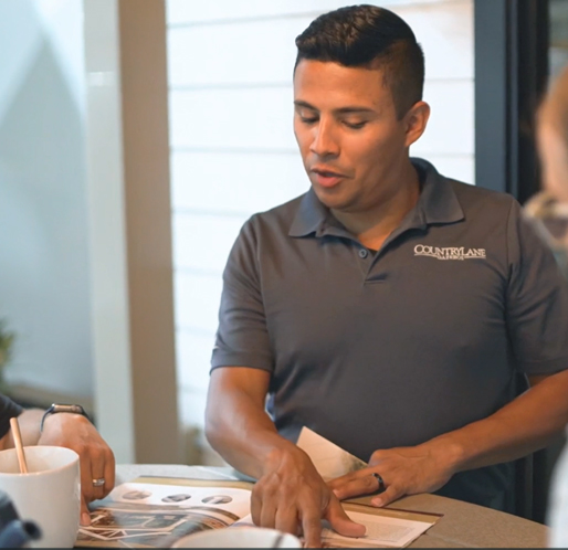 a man in a grey shirt helping customer service