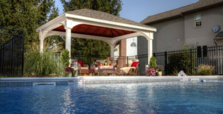 Vinyl, traditional style pavilion with outdoor seating near a pool.