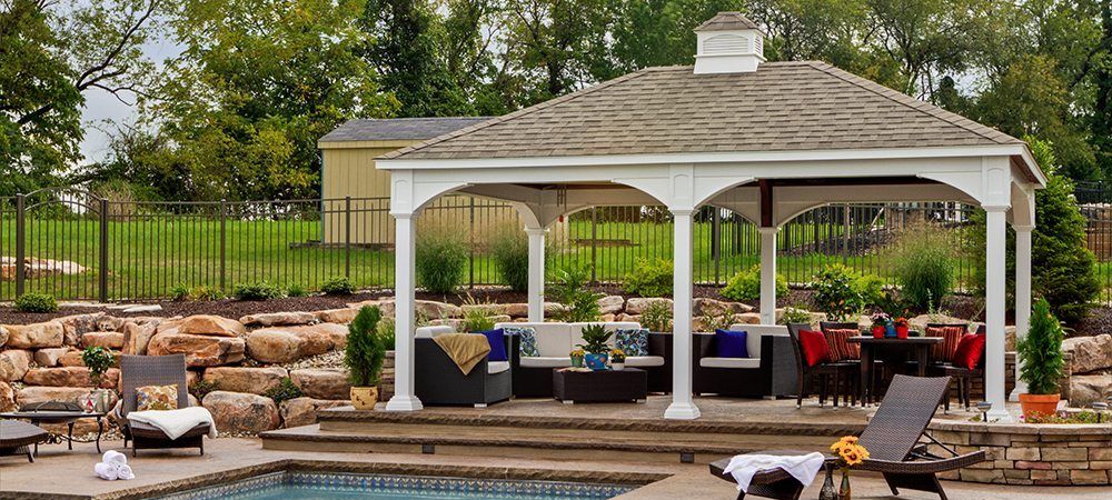 Traditional vinyl pavilion kit with cupola and next to a pool.