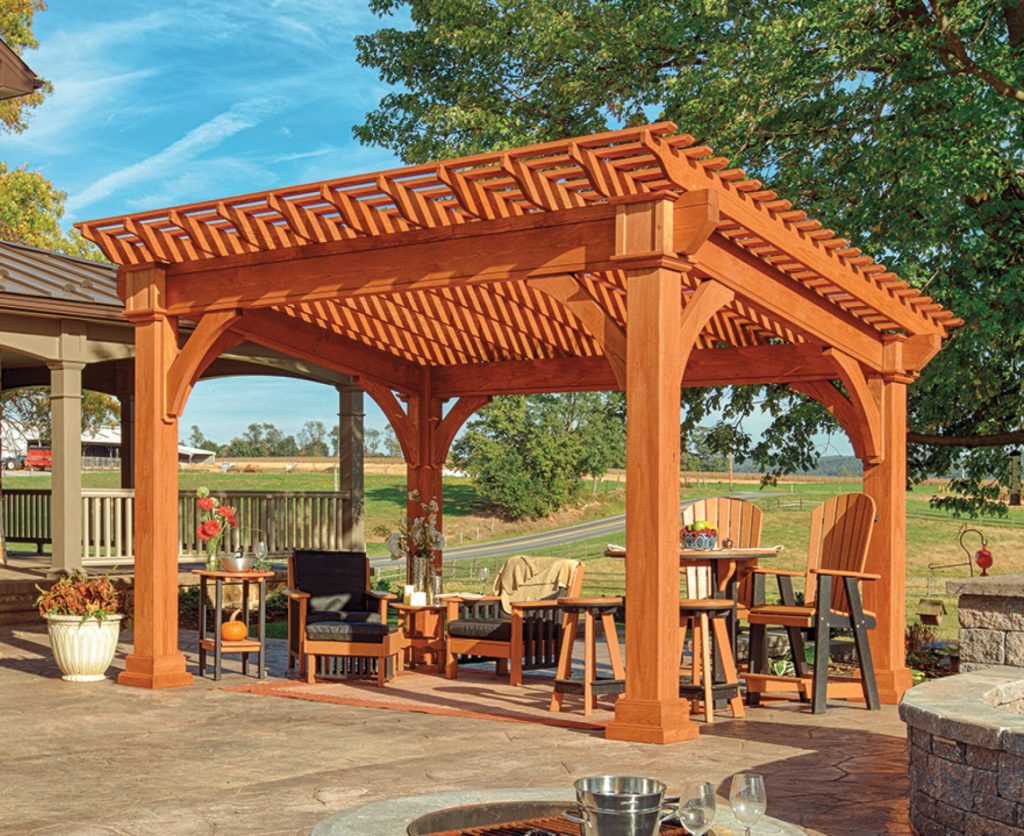a wooden gazebo with a table and chairs under a fire pit