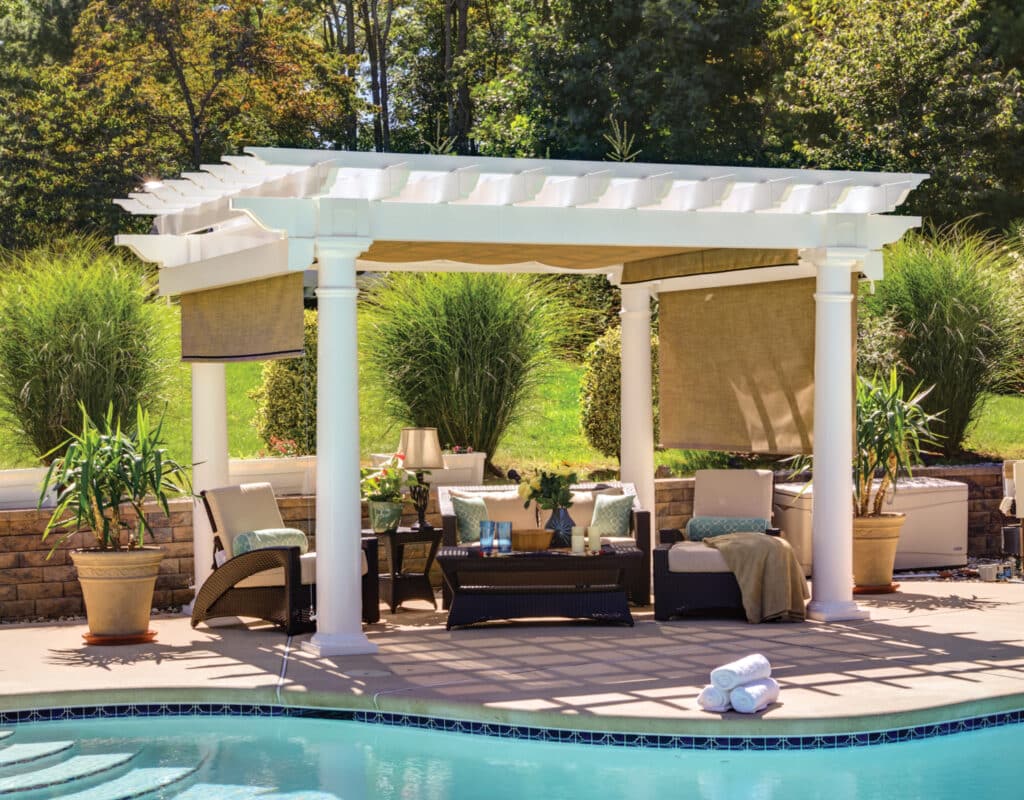 a pool with a white pergola and chairs and added shade