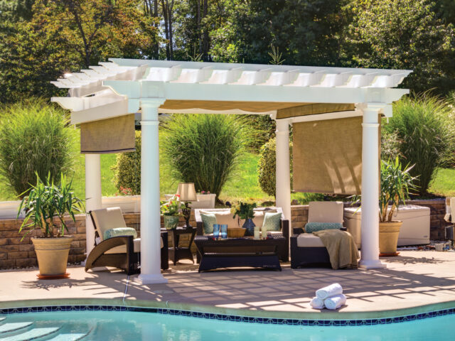 a pool with a white pergola and chairs and added shade