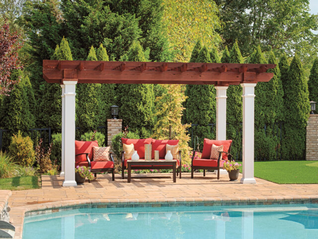 a pool with a pergola and chairs