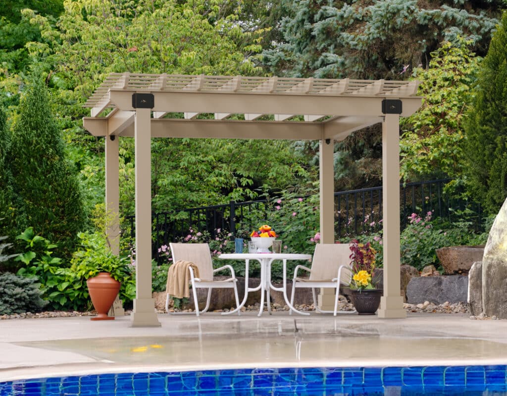 a patio with a table and chairs by a pool with a pergola