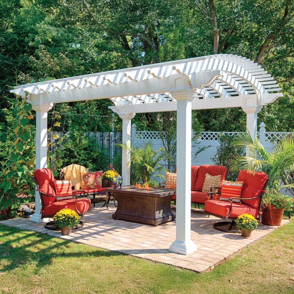 a patio with a table and chairs and white pergola