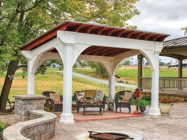 a patio with a covered patio and a fire pit and a pavilion