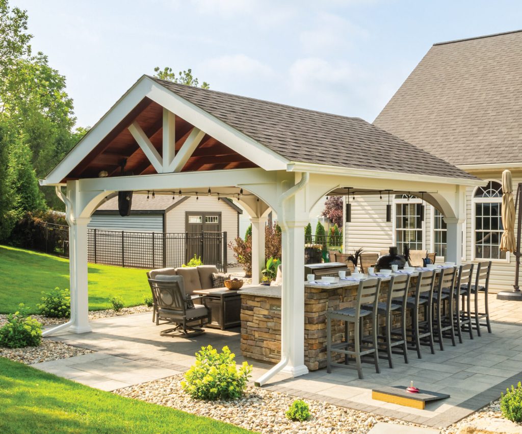 a patio with a pavilion area and a table and chairs and bar