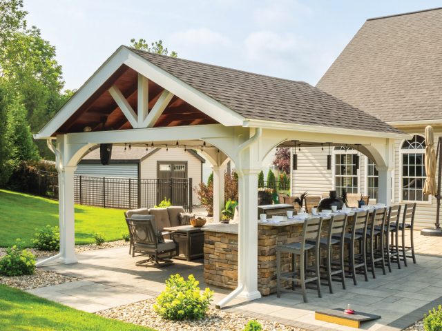 a patio with a pavilion area and a table and chairs and bar