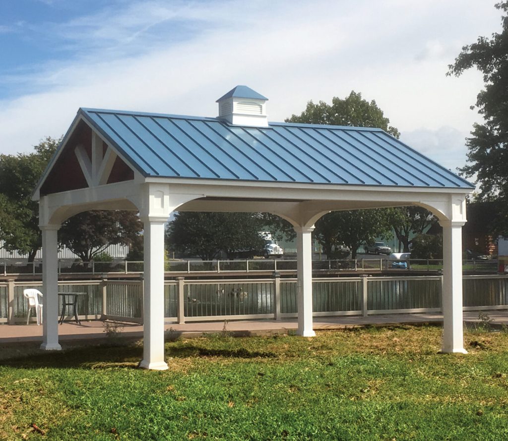a white vinyl pavilion with a blue roof