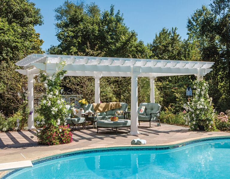 14'x20' Vinyl Artisan(C)_rgb.jpg a pool with a white pergola and chairs