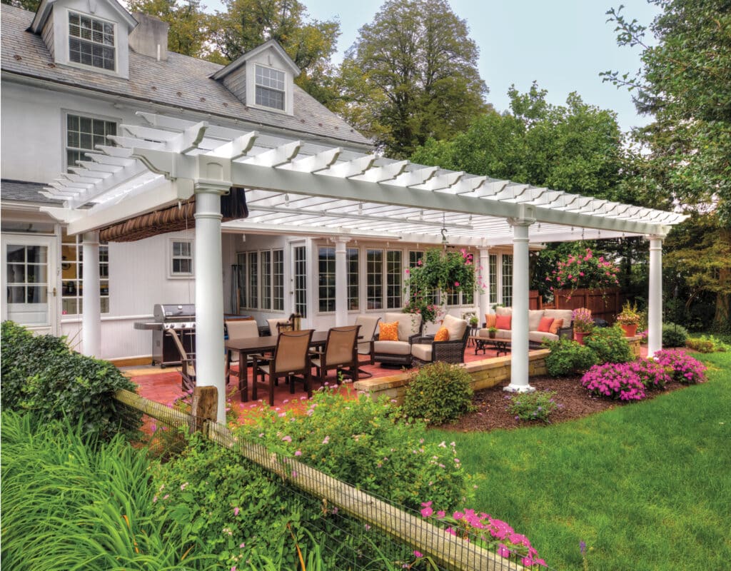 a covered patio with a large white pergola