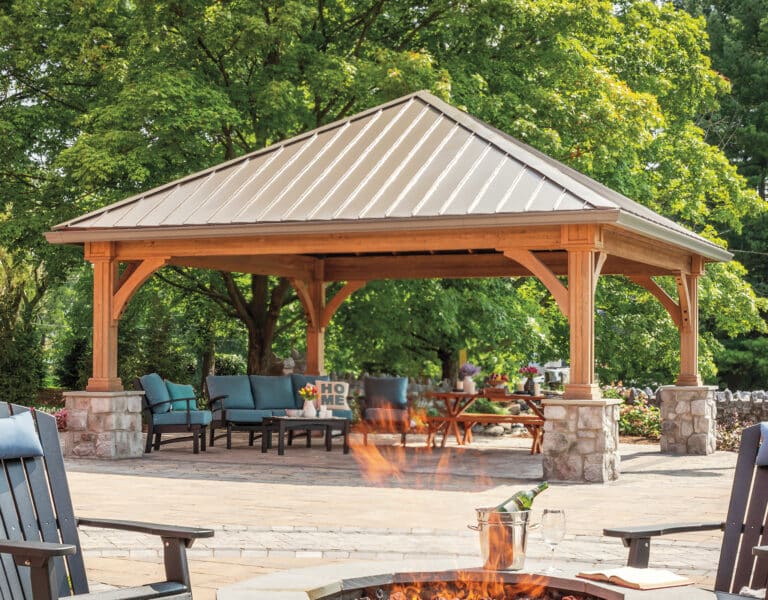 20x20 Wood Grand Estate(MAIN and MIDDLE)_rgb.jpg a large wood pavilion covered patio with a fire pit and chairs