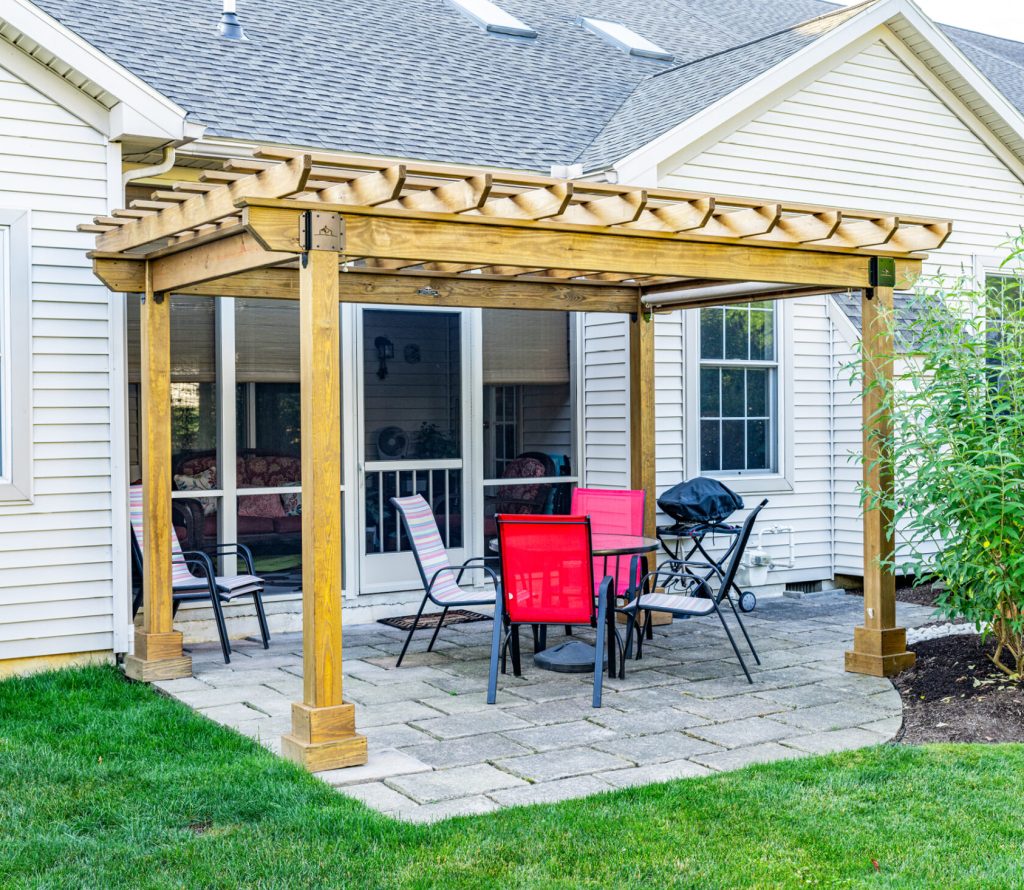 a patio with chairs and a pergola