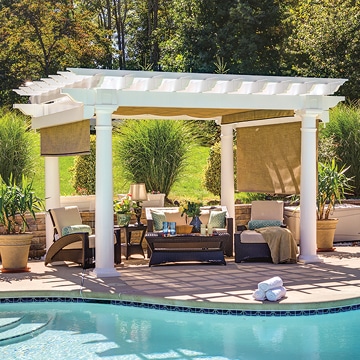 a pool with a white pergola and chairs