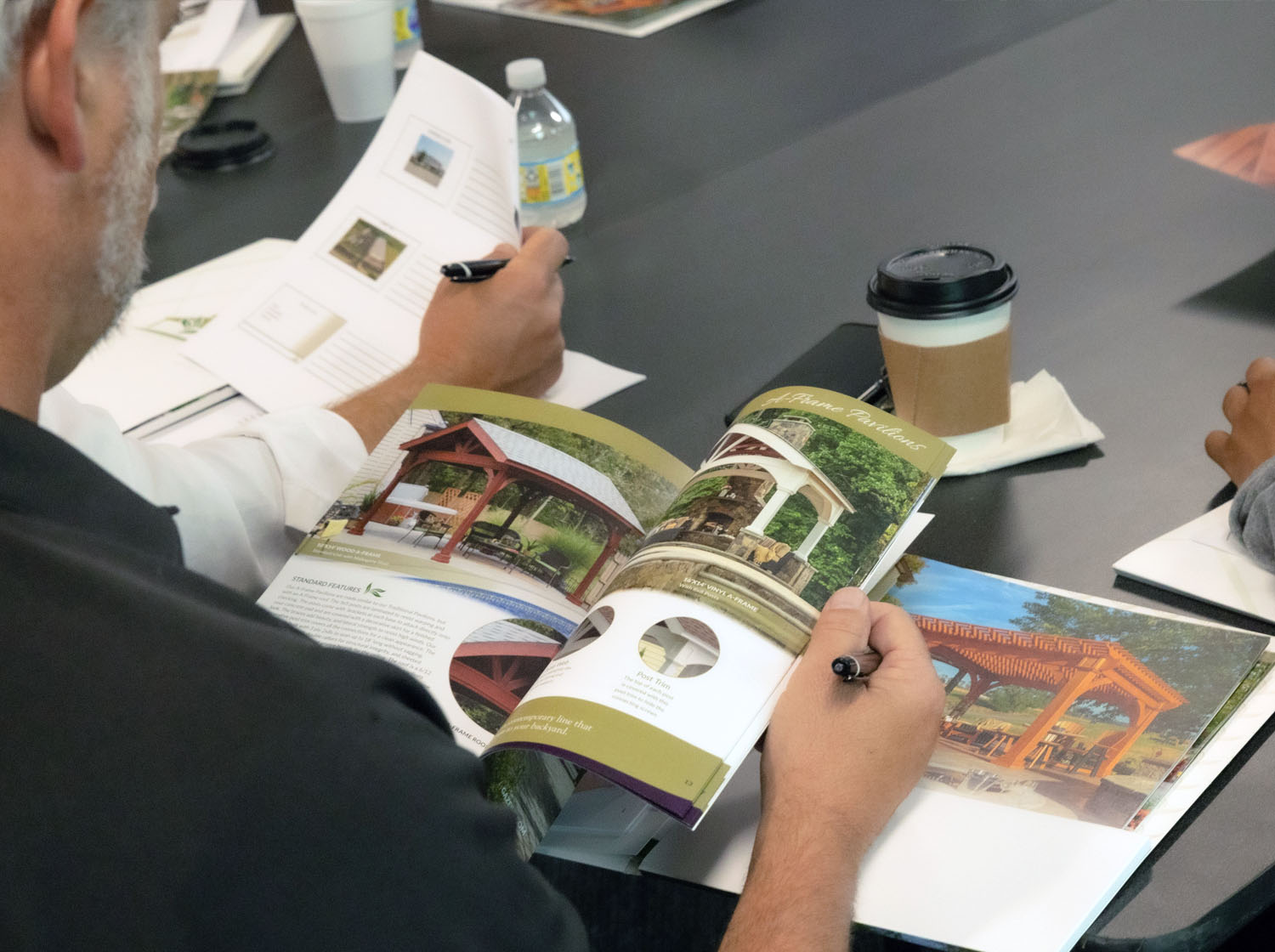 a person holding a pen and pavilion, gazebo, and pergola book