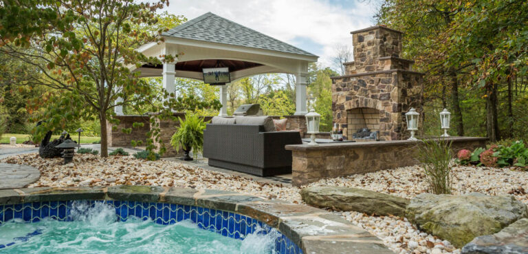 a pool with a grill and a hot tub and pavilion