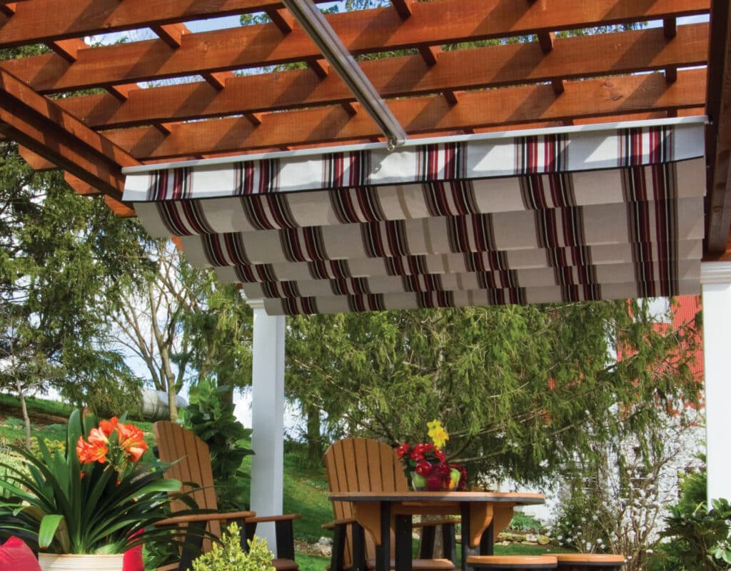 a covered patio with chairs and a table