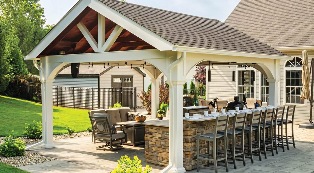 White A-frame pavilion with dining setting and outdoor kitchen