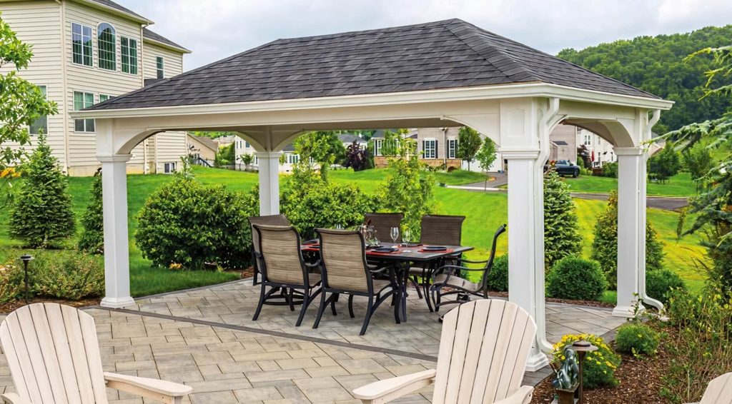 White traditional pavilion with patio furniture underneath