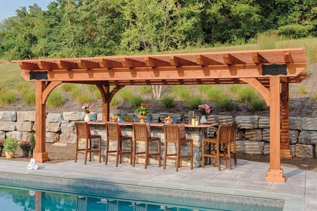 Large pergola with outdoor bar seating beside a pool
